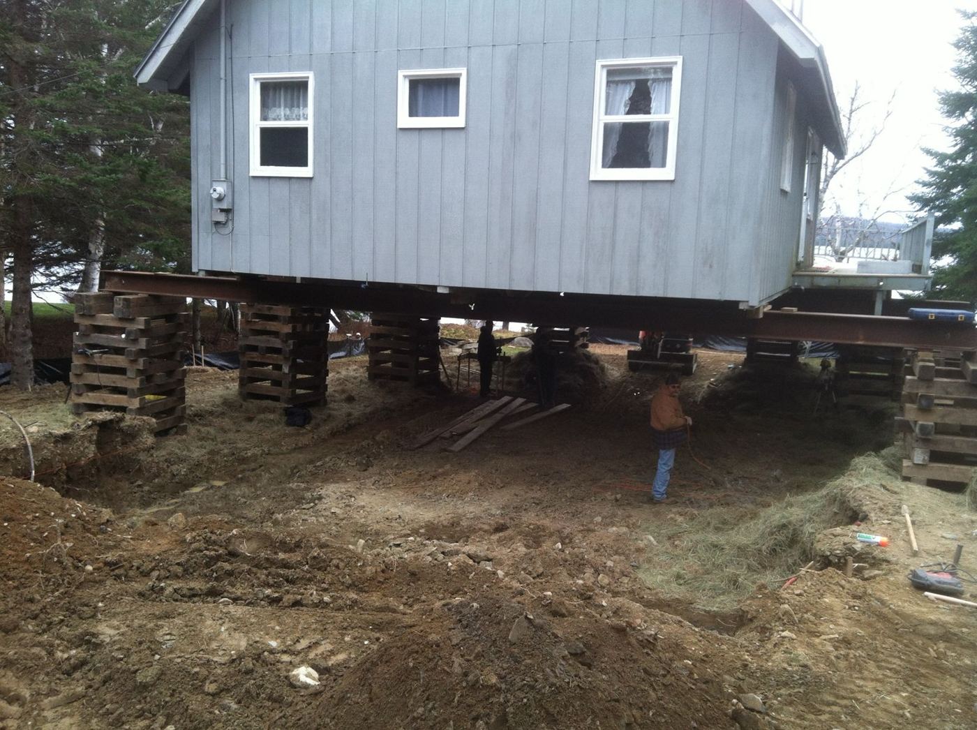 Gray camp raised on timber cribbing over the excavated site