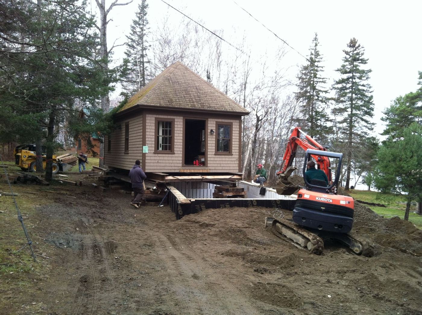 Crew setting the camp onto its new foundation