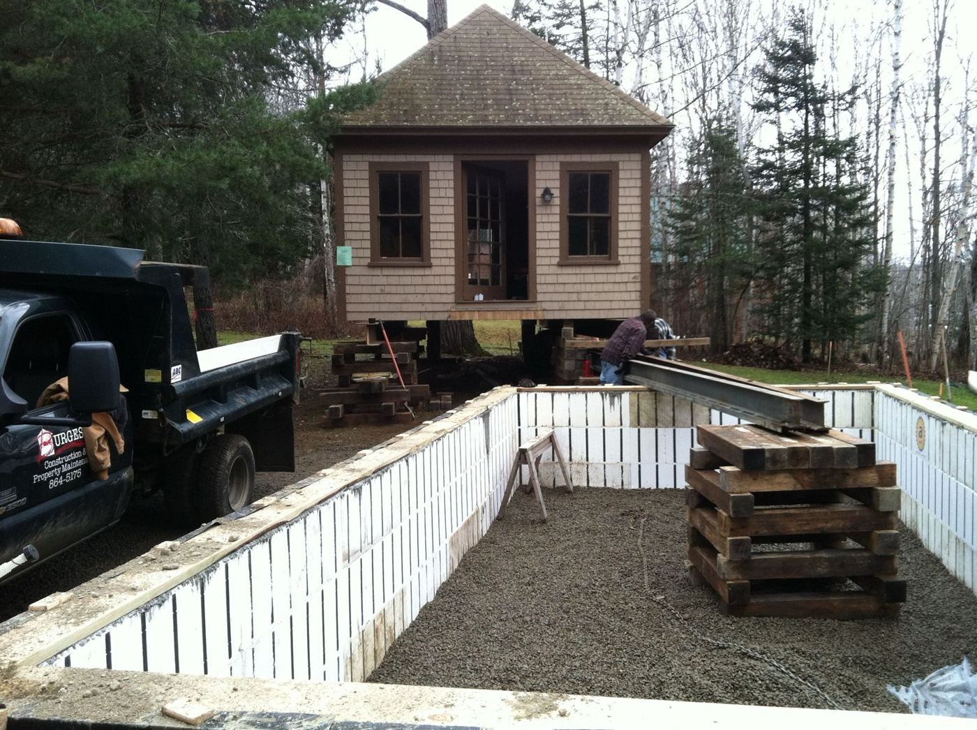 New ICF foundation walls built beside the raised camp, with a Burgess truck