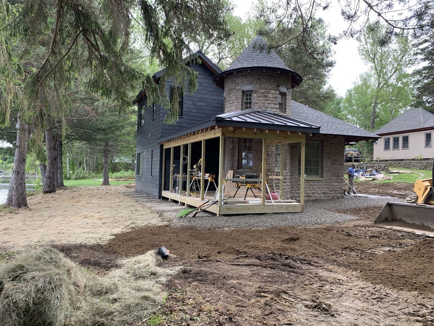 Stone and shingle lake cottage with a new porch under construction