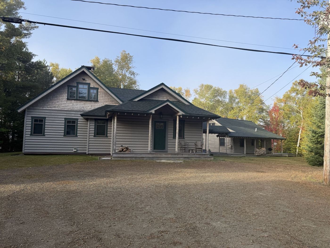 Well-kept log-sided home with a freshly graded gravel drive