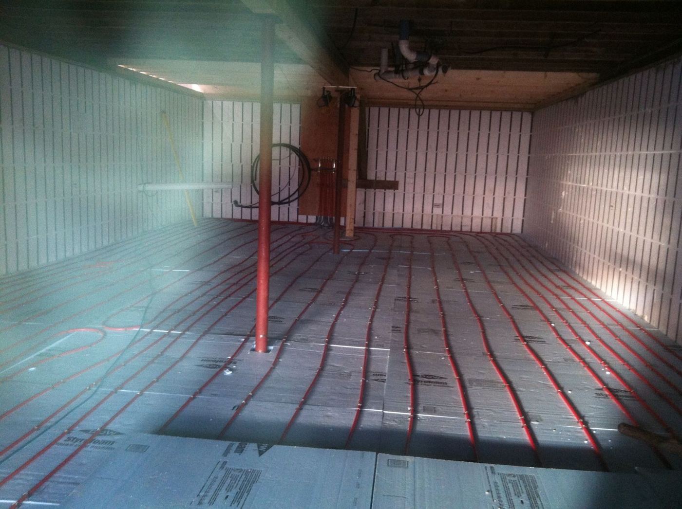 Radiant floor heat tubing laid over insulation before the slab is poured